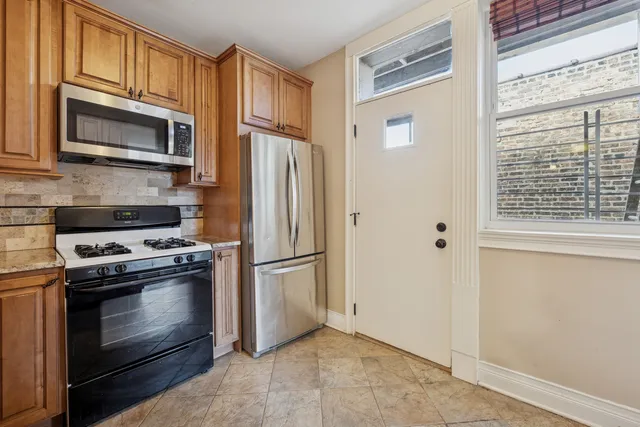 a kitchen with a stove microwave and refrigerator