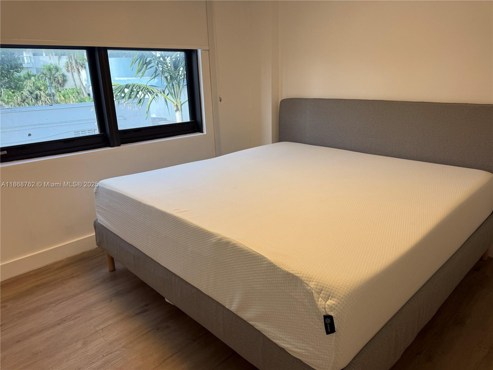 4301 Collins Avenue, Unit 208 Miami Beach, FL 33140 - Photo 11 of 28 a bed sitting in a bedroom next to a window