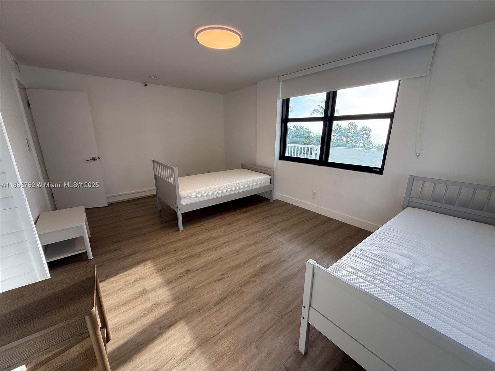 4301 Collins Avenue, Unit 208 Miami Beach, FL 33140 - Photo 14 of 28 a living room with wooden floor and a window