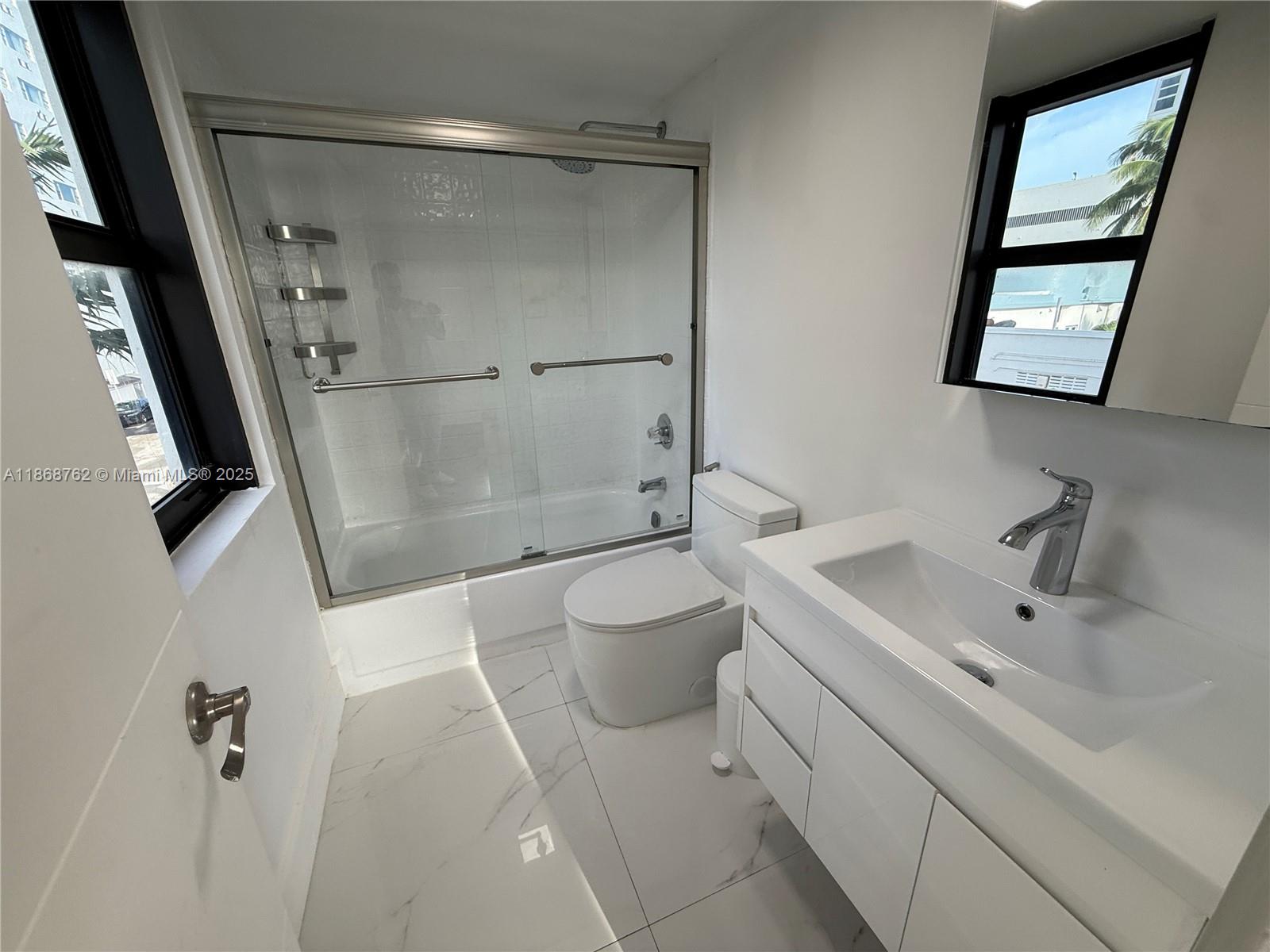 4301 Collins Avenue, Unit 208 Miami Beach, FL 33140 - Photo 18 of 28 a bathroom with a sink toilet and shower