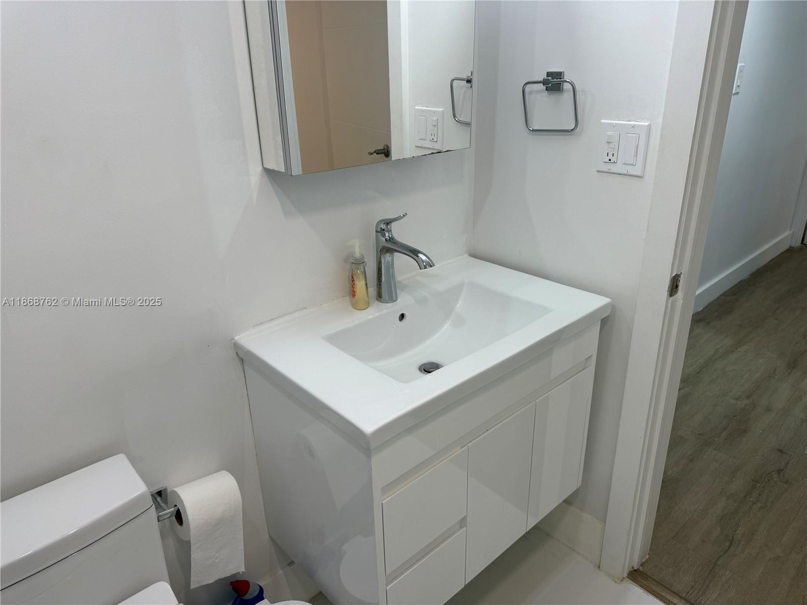 4301 Collins Avenue, Unit 208 Miami Beach, FL 33140 - Photo 9 of 28 a bathroom with a sink a toilet and mirror