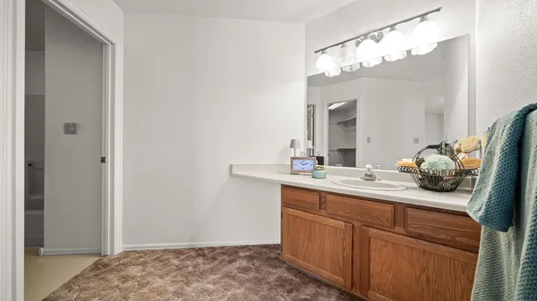 a en suite bathroom with a sink and mirror