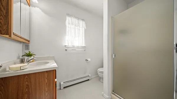 a bathroom with a sink toilet and window