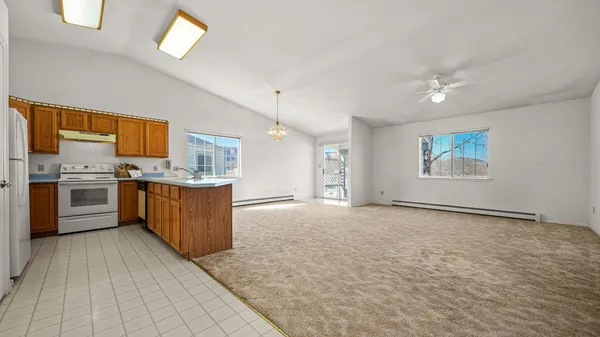 a kitchen with stainless steel appliances granite countertop a stove a sink and a refrigerator