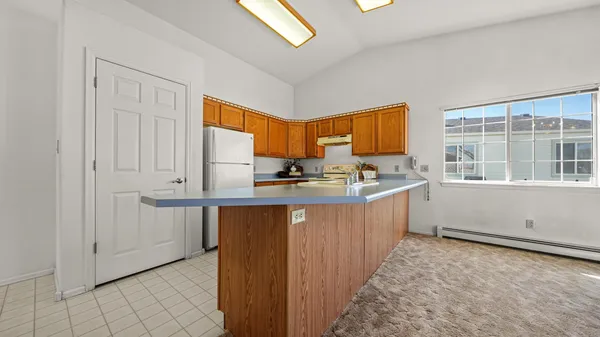 a kitchen with granite countertop a sink cabinets and window