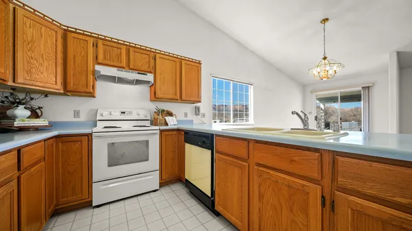 a kitchen with granite countertop stainless steel appliances sink and cabinets