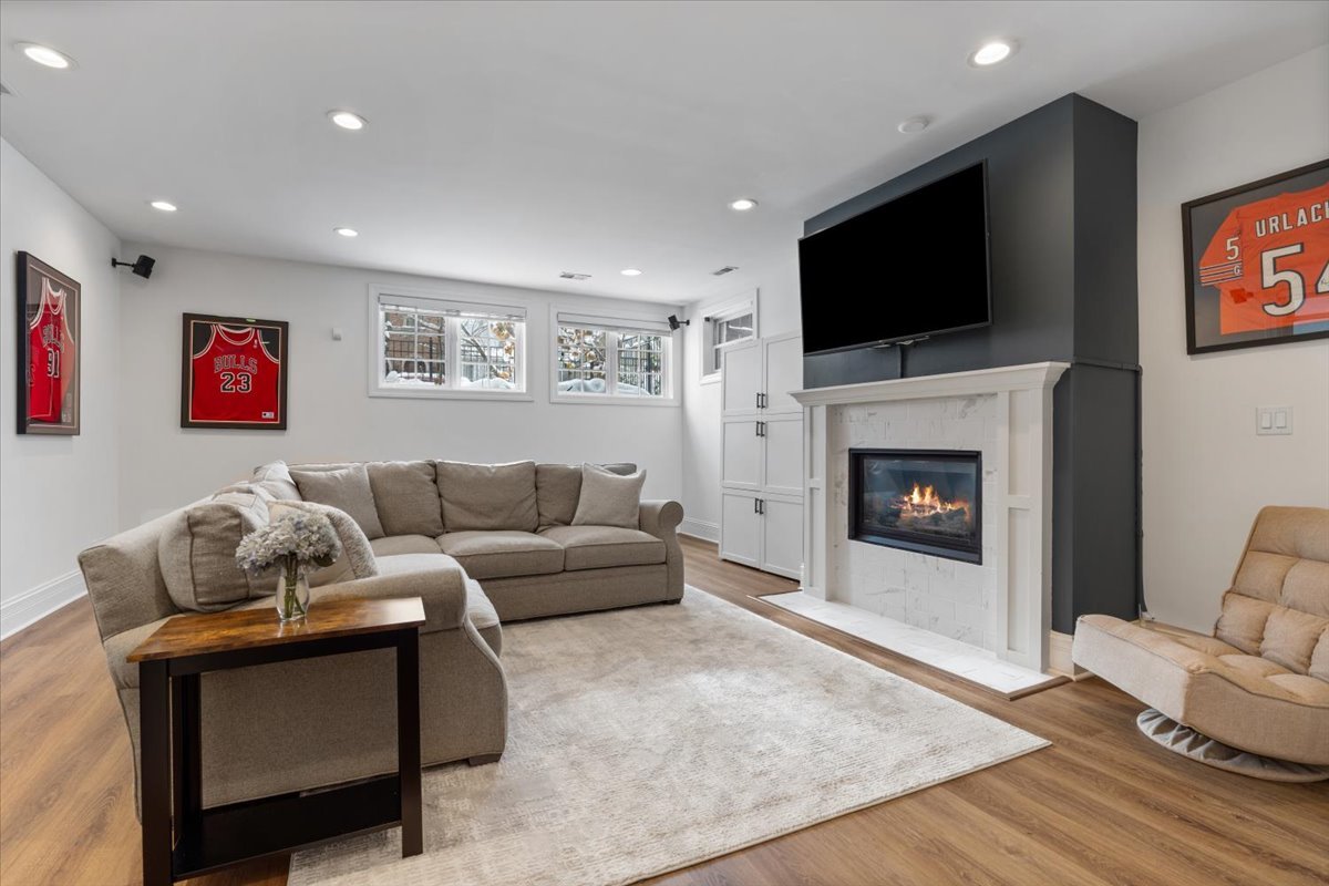 1920 West George Street Chicago, IL 60657 - Photo 26 of 36 a living room with furniture a flat screen tv and a fireplace
