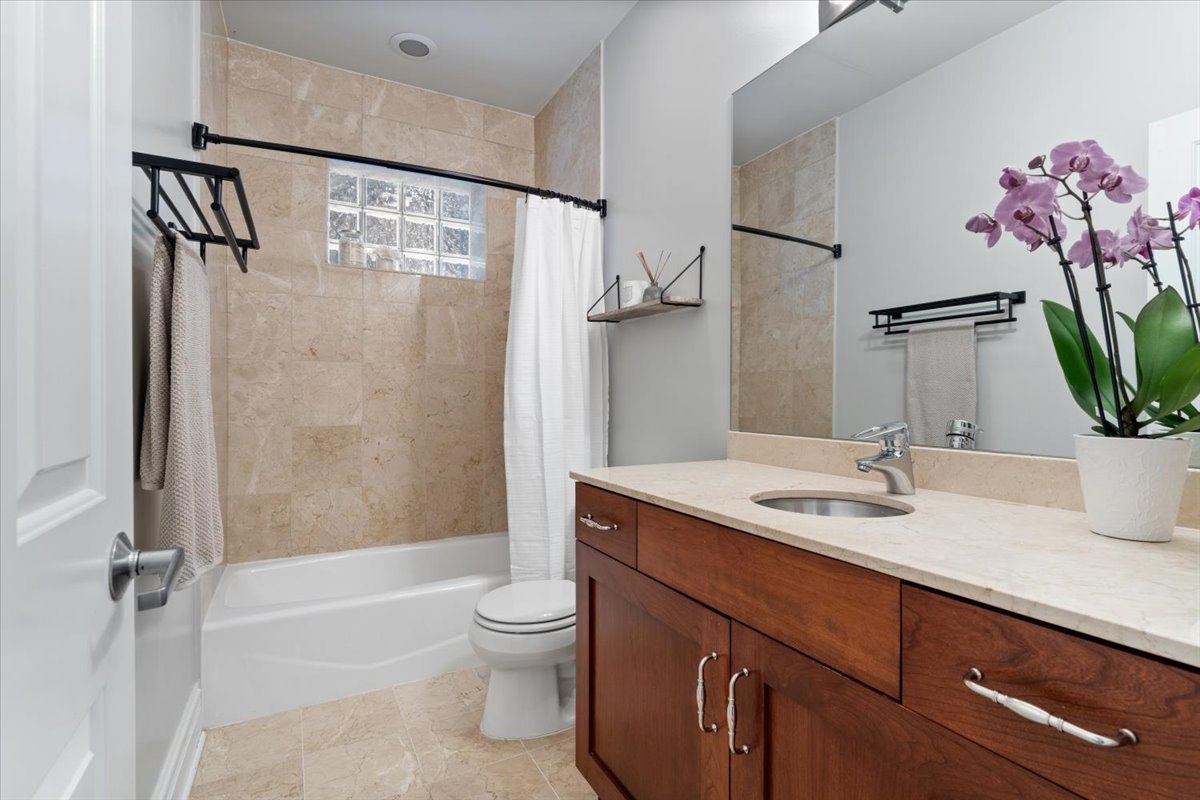 1920 West George Street Chicago, IL 60657 - Photo 32 of 36 a bathroom with a sink a toilet and shower