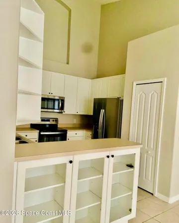 a kitchen with stainless steel appliances a refrigerator sink and microwave