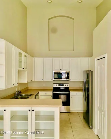a kitchen with stainless steel appliances granite countertop a refrigerator a stove top oven a sink and dishwasher