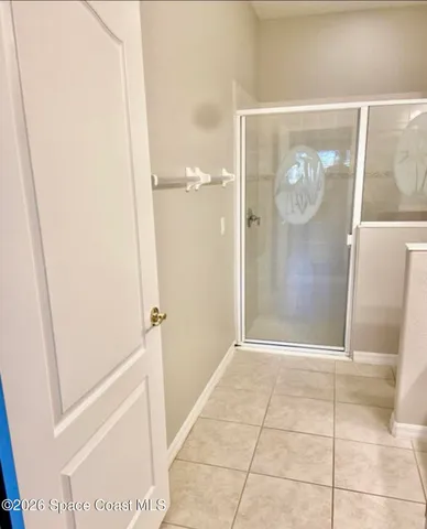 a bathroom with a glass door shower