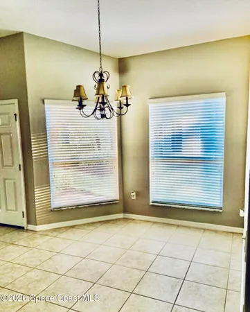 a view of a room with a mirror and furniture