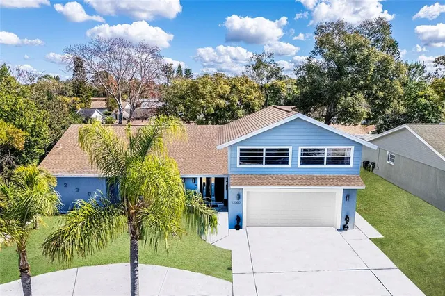a front view of a house with a yard and trees