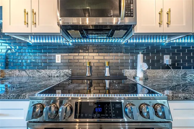 a kitchen with a refrigerator and table