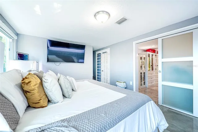a view of walk in closet with clothes shoes and a large mirror
