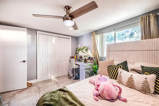 a bedroom with furniture and a flat screen tv