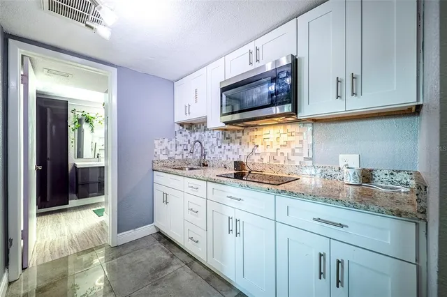 a view of a bedroom with wooden floor and a potted plant