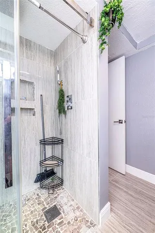 a view of empty room with wooden floor