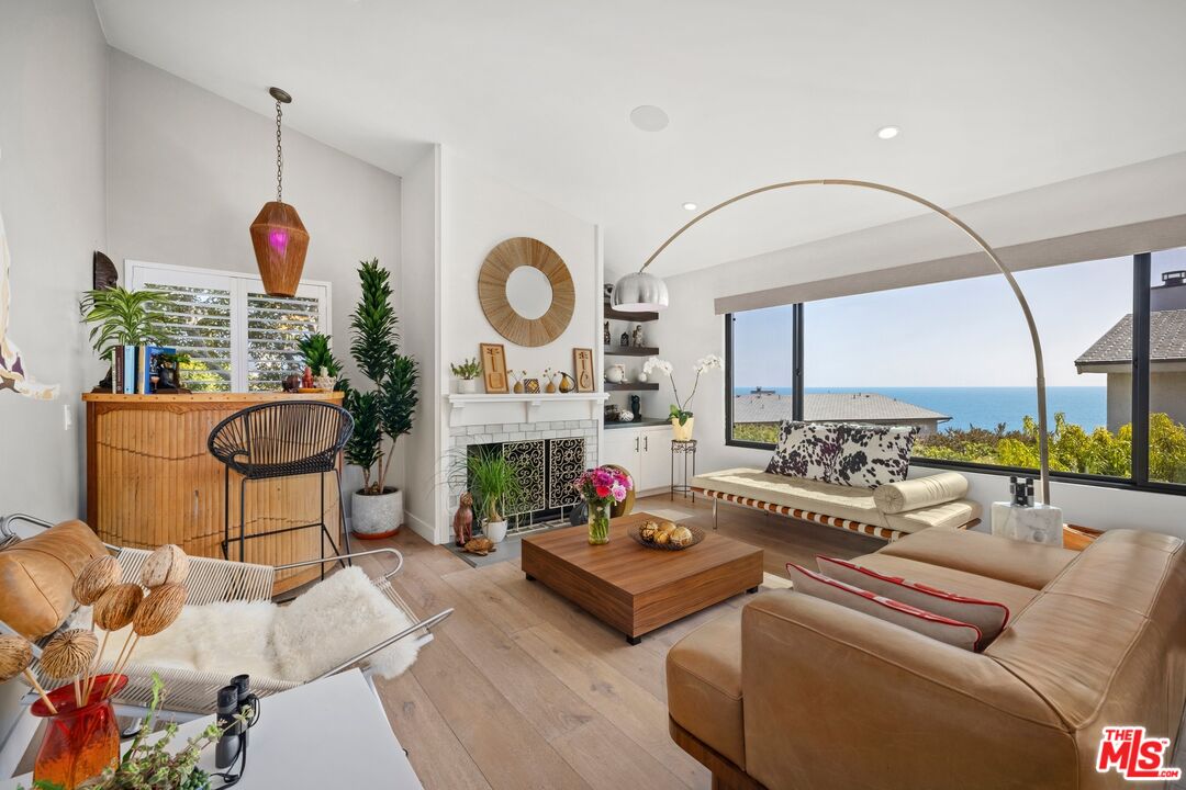 a living room with furniture fireplace and window