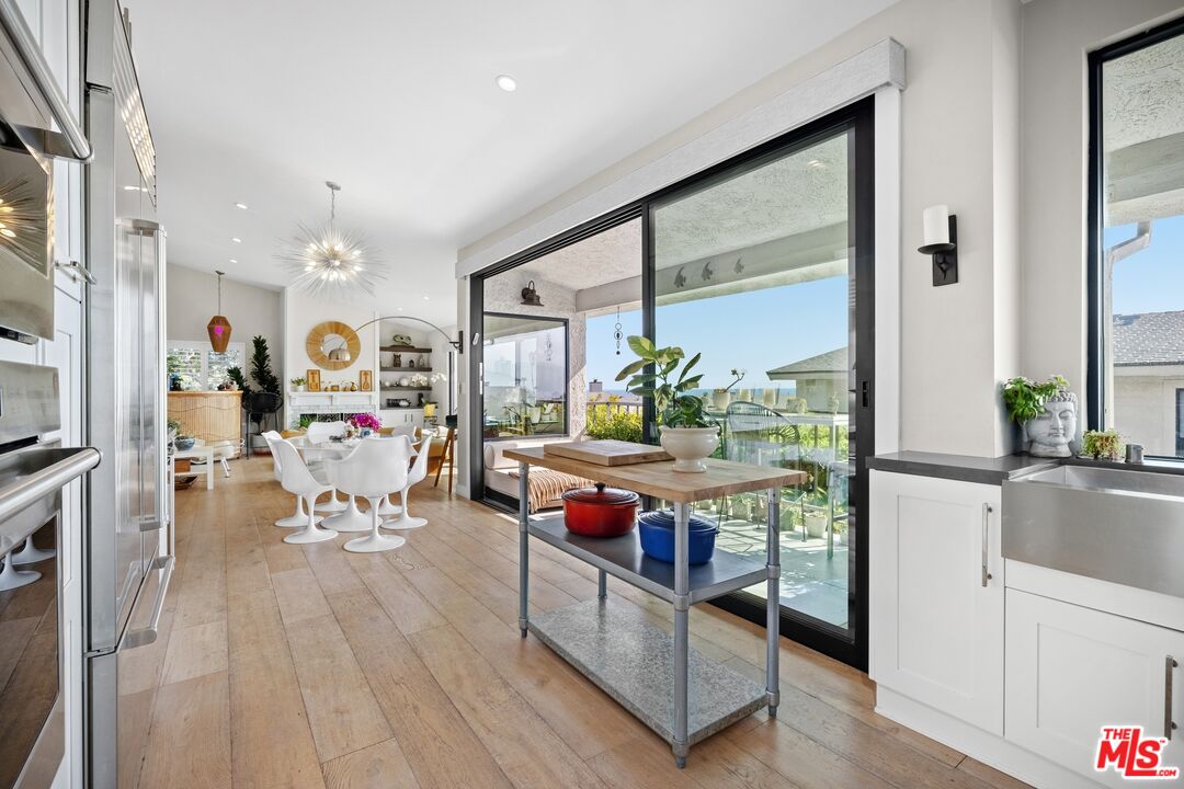 6795 Las Olas Way Malibu, CA 90265 - Photo 11 of 26 a living room with furniture and a large window