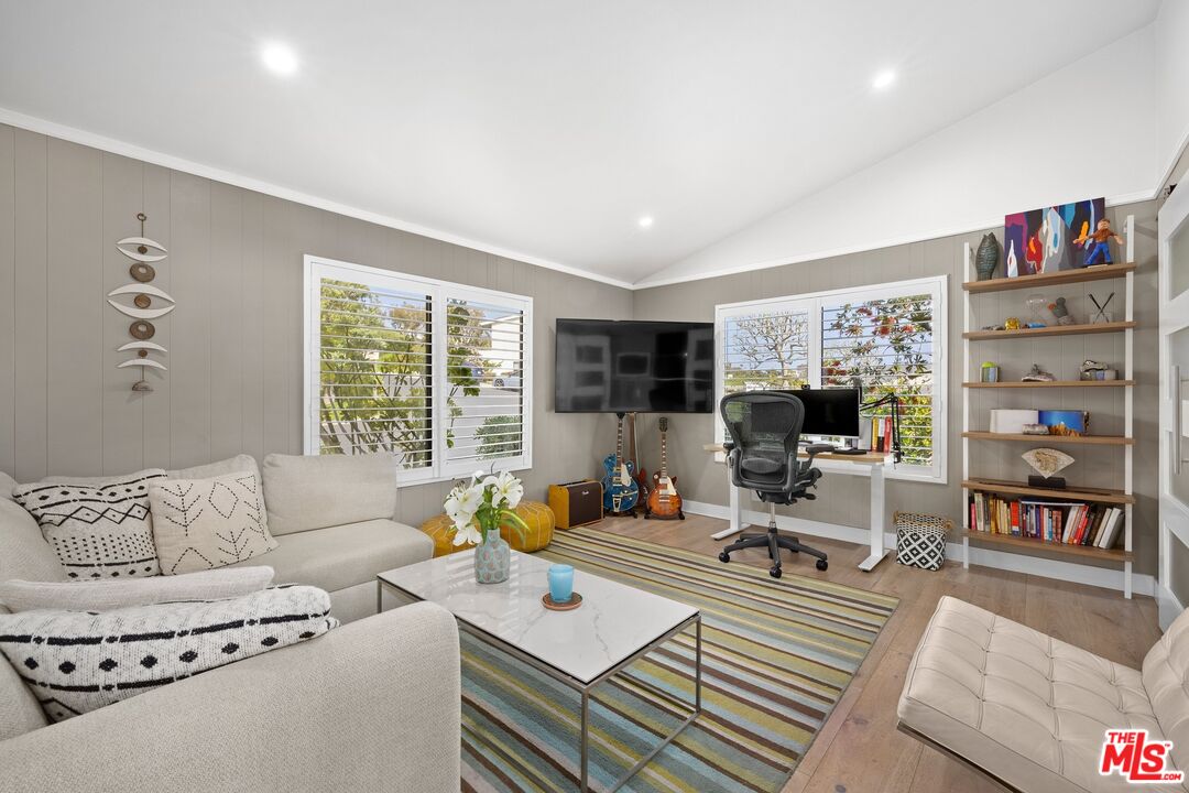 6795 Las Olas Way Malibu, CA 90265 - Photo 13 of 26 a living room with furniture and a flat screen tv