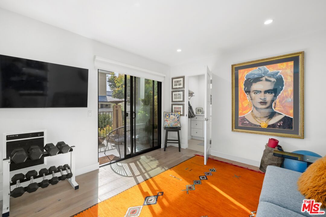 6795 Las Olas Way Malibu, CA 90265 - Photo 18 of 26 a living room with furniture flat screen tv and floor to ceiling window