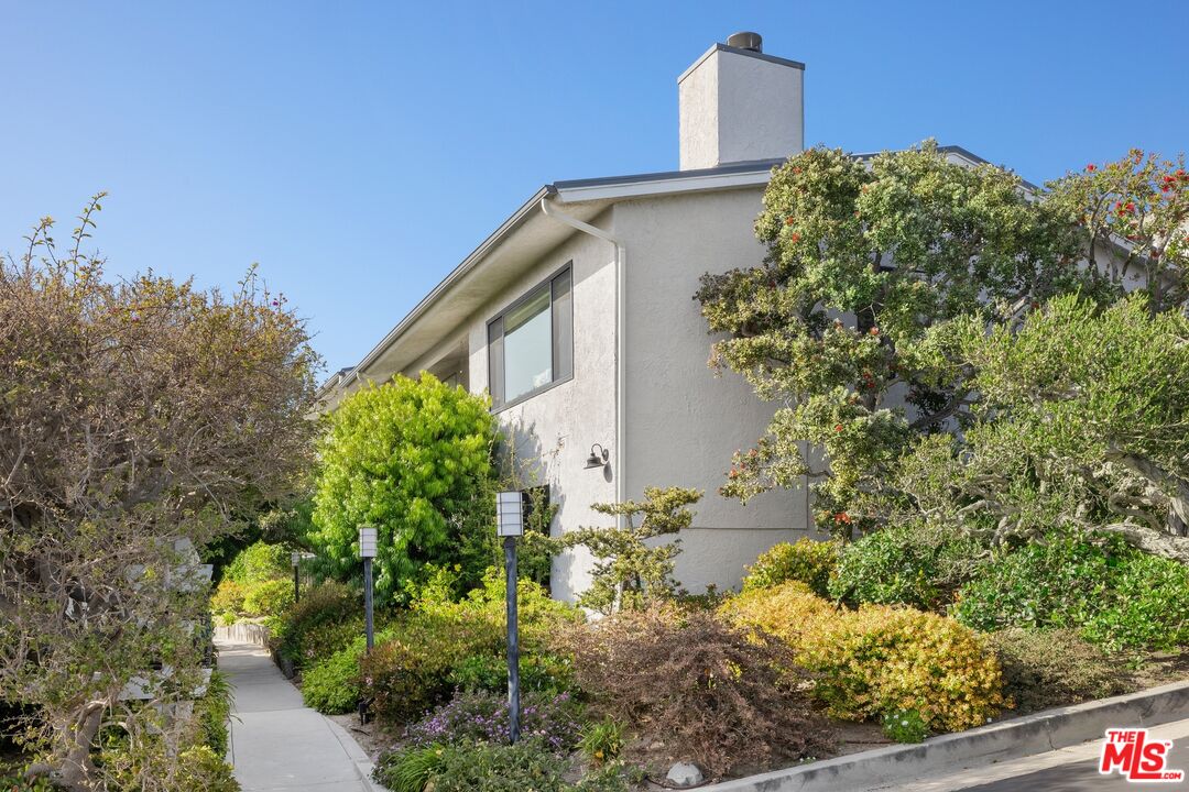 6795 Las Olas Way Malibu, CA 90265 - Photo 20 of 26 a view of a house with a yard and plants