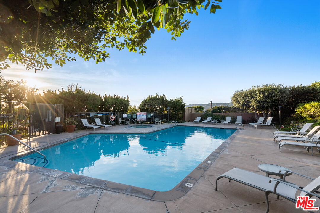 6795 Las Olas Way Malibu, CA 90265 - Photo 23 of 26 a view of a swimming pool with outdoor seating and plants