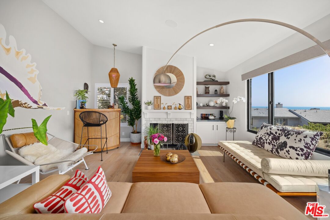 6795 Las Olas Way Malibu, CA 90265 - Photo 4 of 26 a living room with furniture and a fireplace