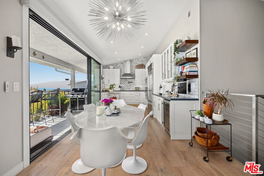 6795 Las Olas Way Malibu, CA 90265 - Photo 6 of 26 a dining room with furniture and a floor to ceiling window