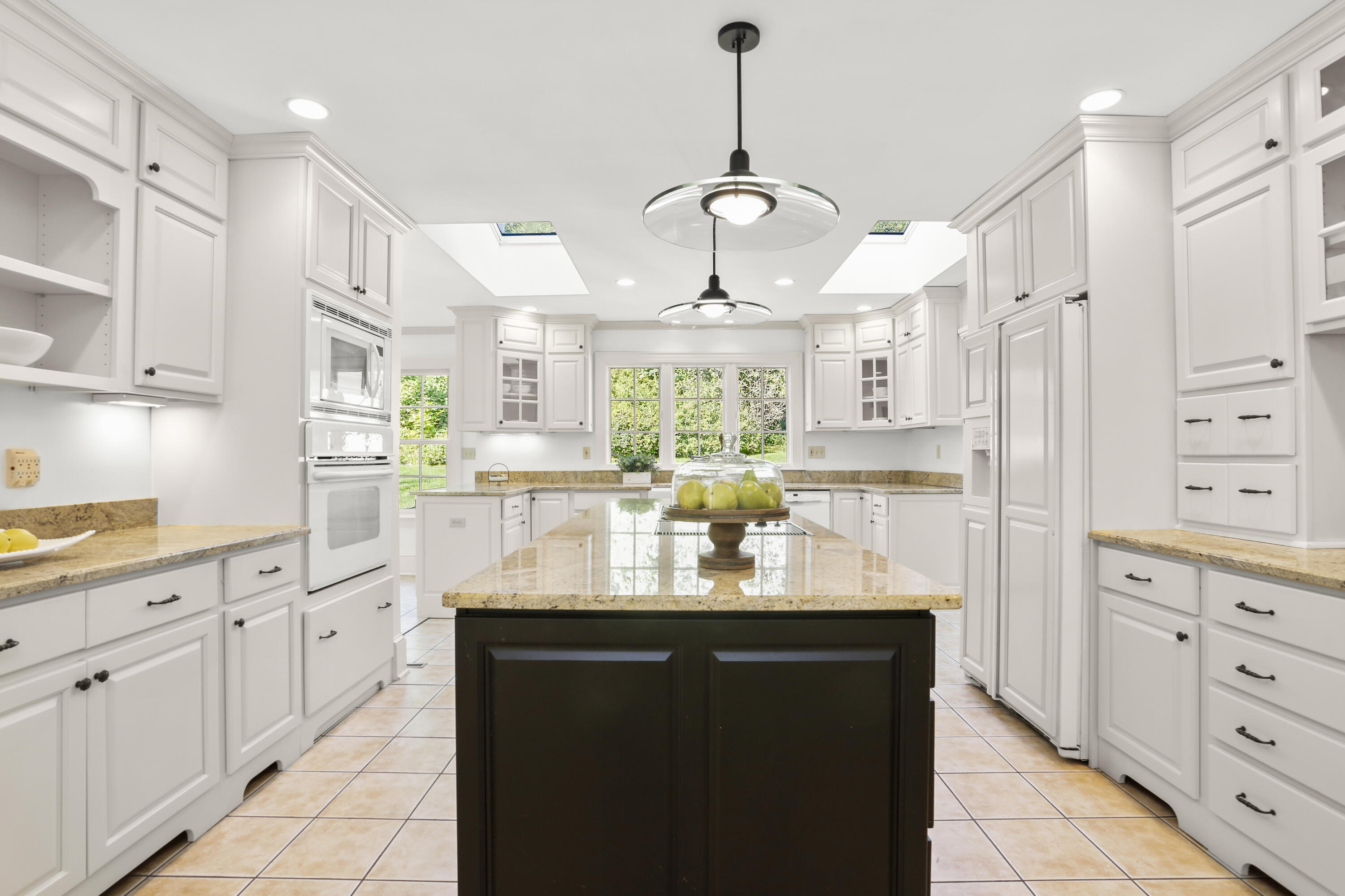 110 Sleepy Hollow Road New Canaan, CT 06840 - Photo 13 of 47 a kitchen with kitchen island granite countertop stainless steel appliances a sink a stove a refrigerator and cabinets