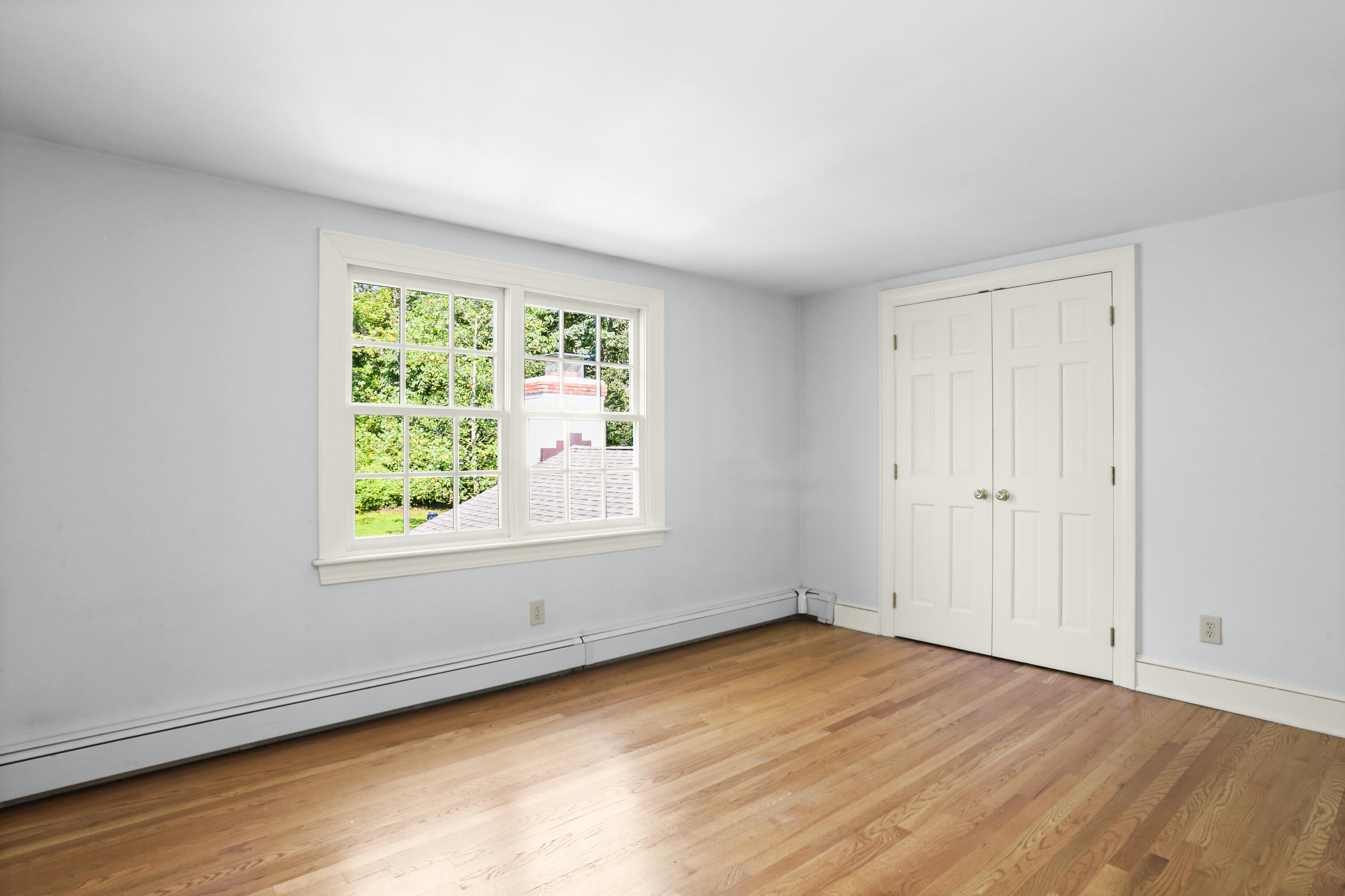 110 Sleepy Hollow Road New Canaan, CT 06840 - Photo 25 of 47 an empty room with wooden floor and windows