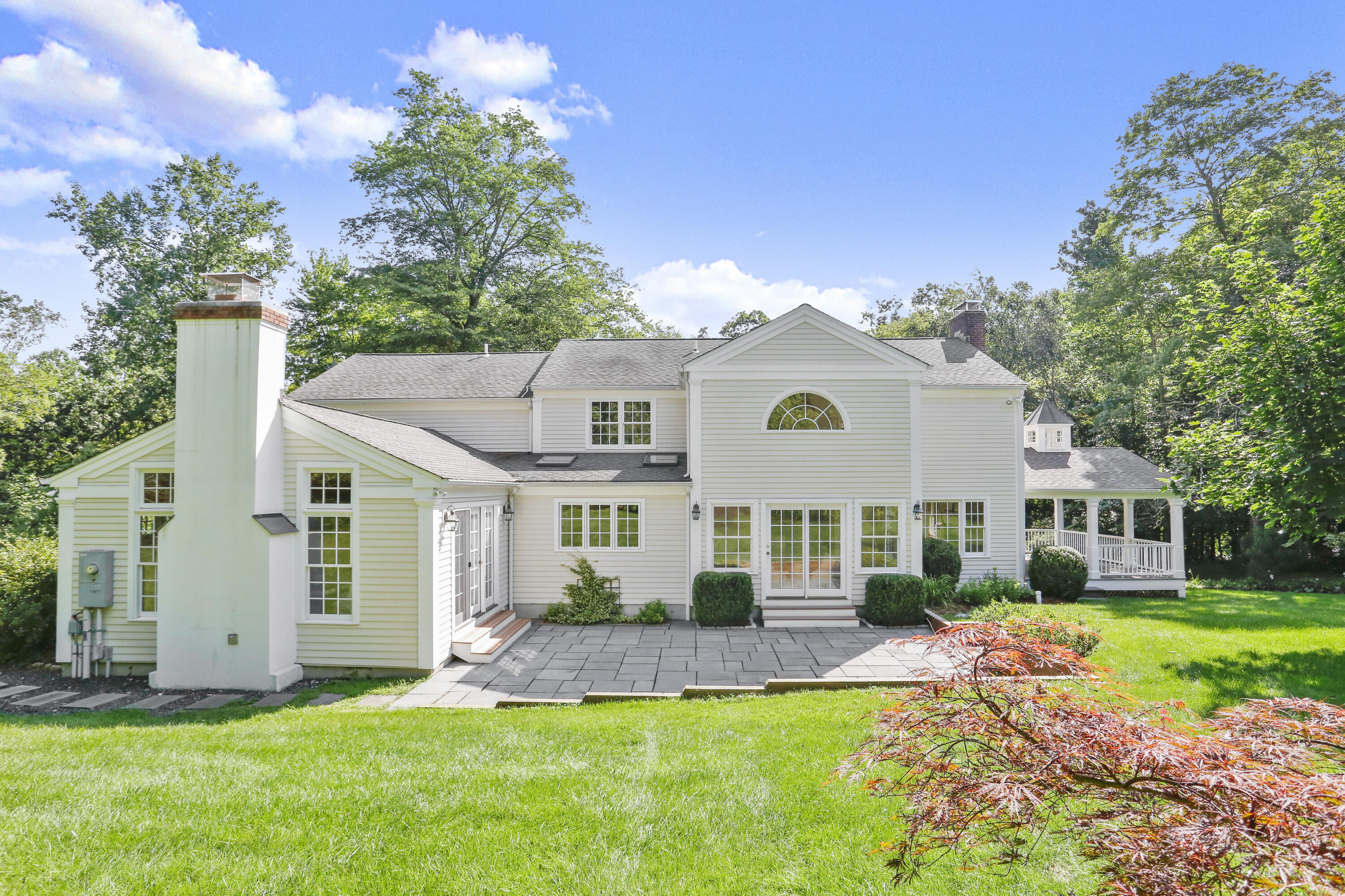 110 Sleepy Hollow Road New Canaan, CT 06840 - Photo 4 of 47 a front view of a house with a yard and garage