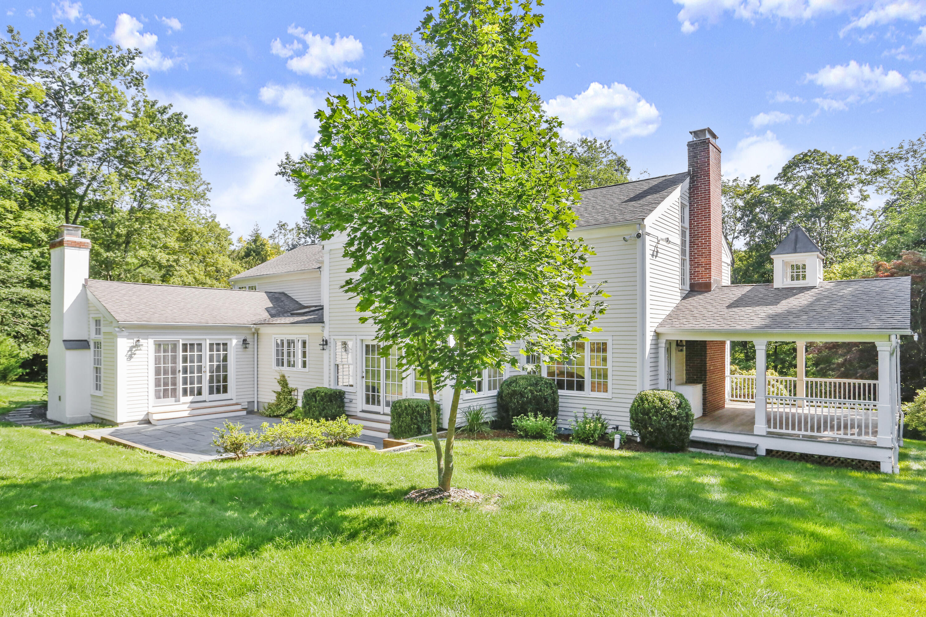 110 Sleepy Hollow Road New Canaan, CT 06840 - Photo 36 of 47 a view of house with a big yard and potted plants