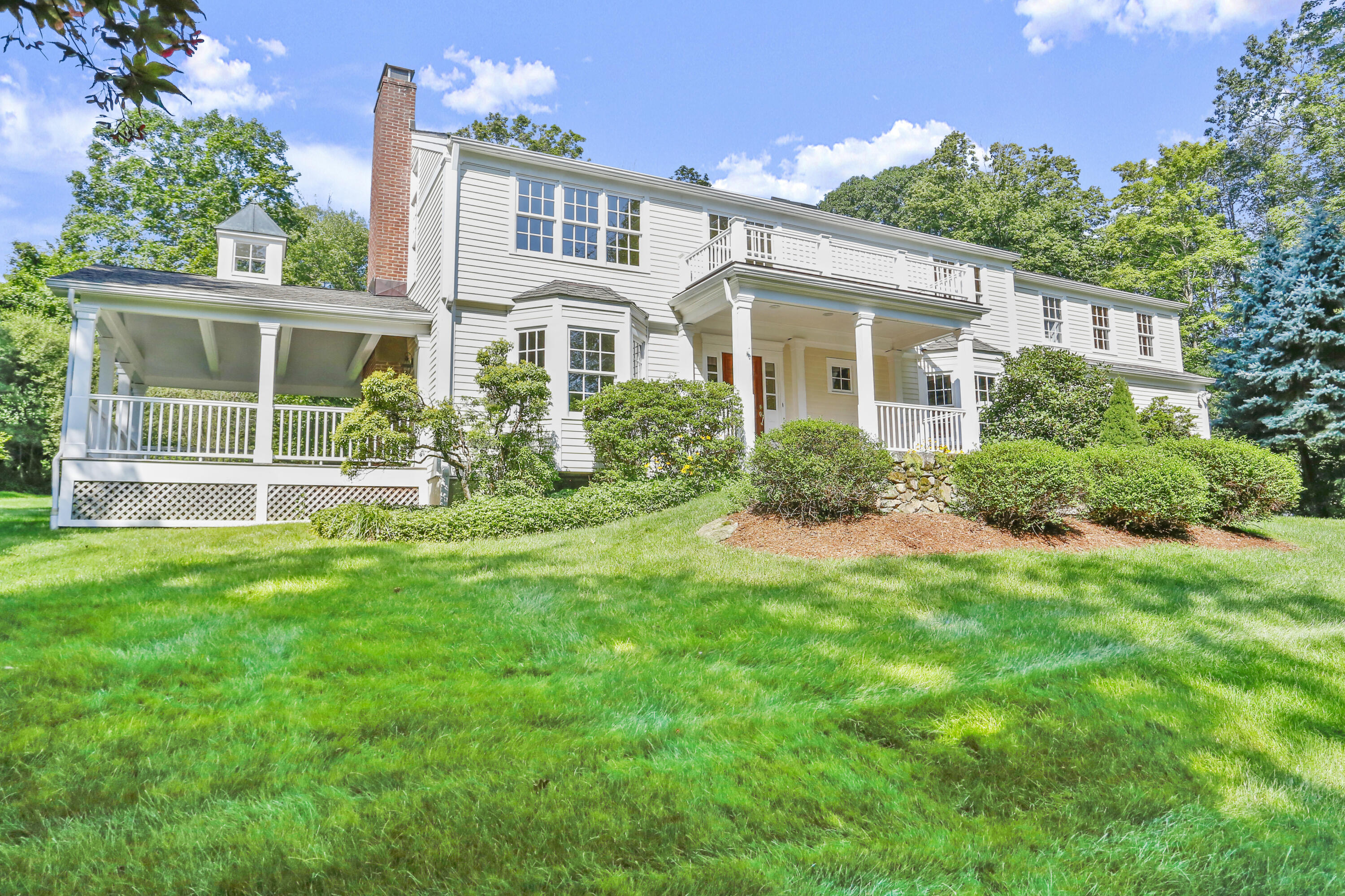 110 Sleepy Hollow Road New Canaan, CT 06840 - Photo 41 of 47 a front view of a house with a yard