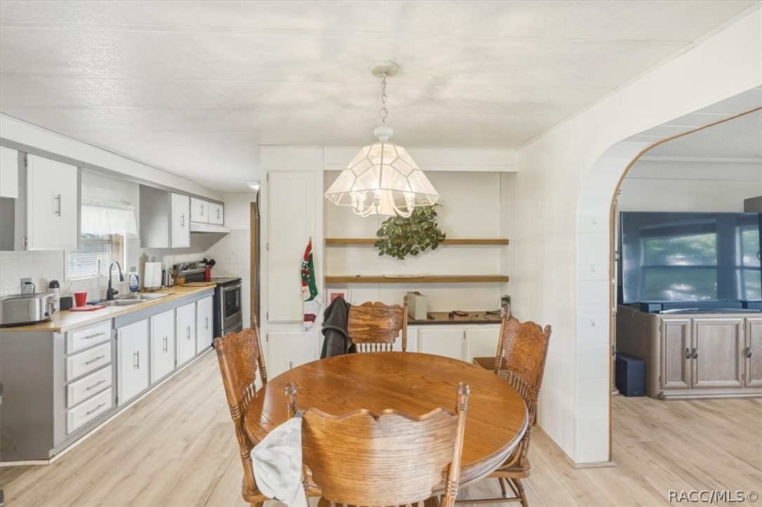 928 South Shad Terrace Inverness, FL 34450 - Photo 5 of 48 a view of a dining room with furniture window and wooden floor