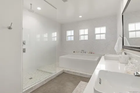 a bathroom with a tub sink and mirror