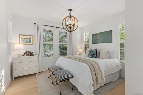 a bedroom with a bed window and a television