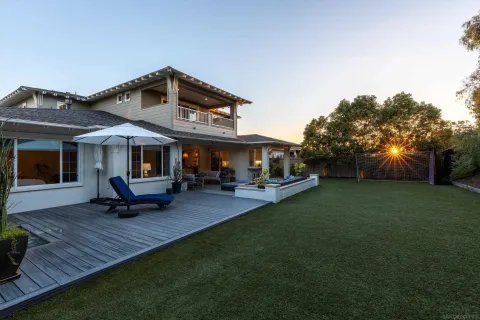 a view of a house with backyard porch and sitting area