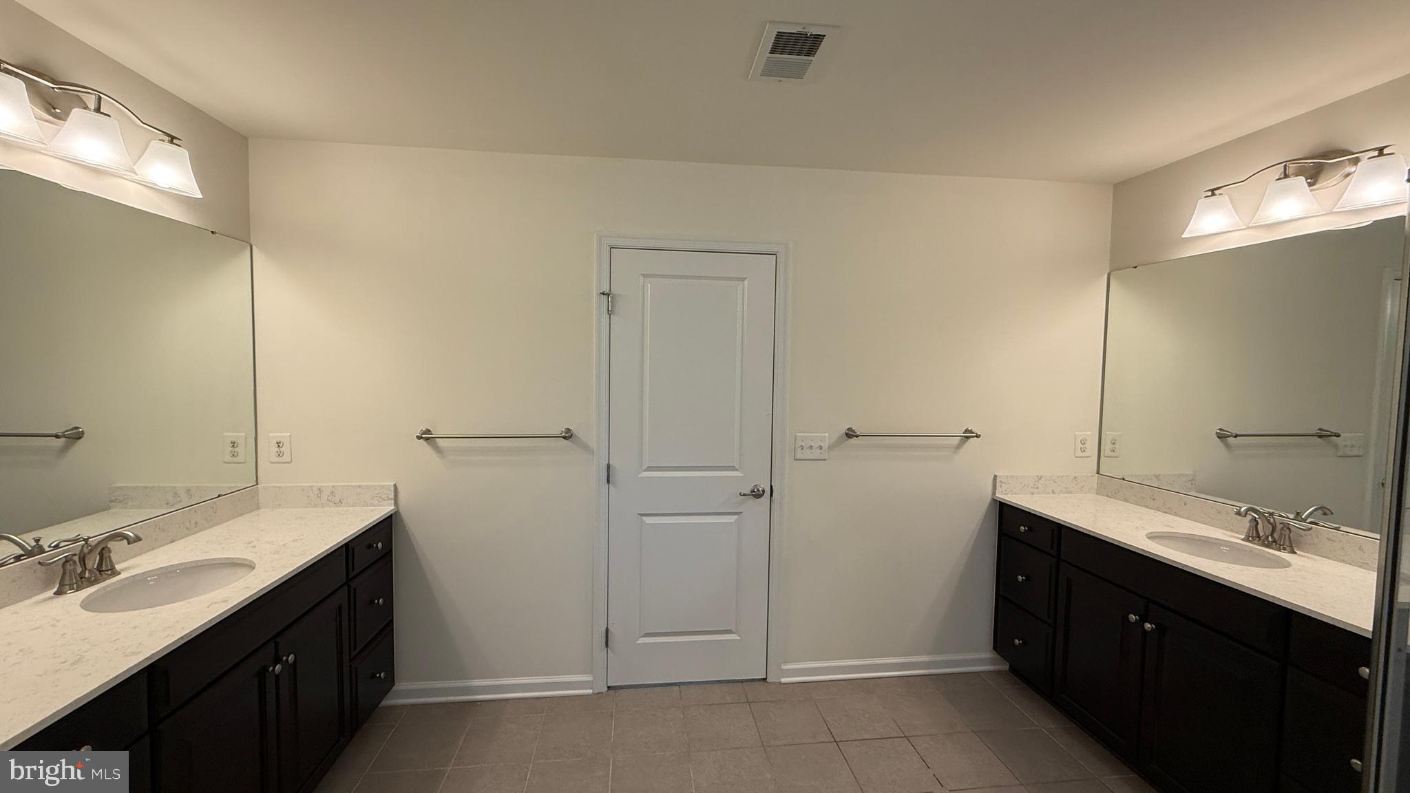 12421 Mays Quarter Road Woodbridge, VA 22192 - Photo 17 of 30 a bathroom with a double vanity sink and mirror