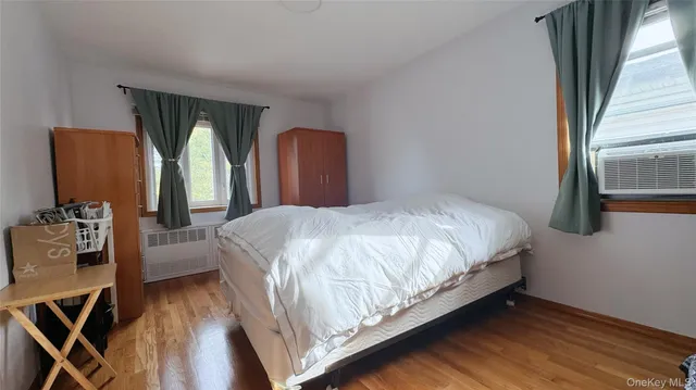 a large bed sitting in a bedroom next to a window