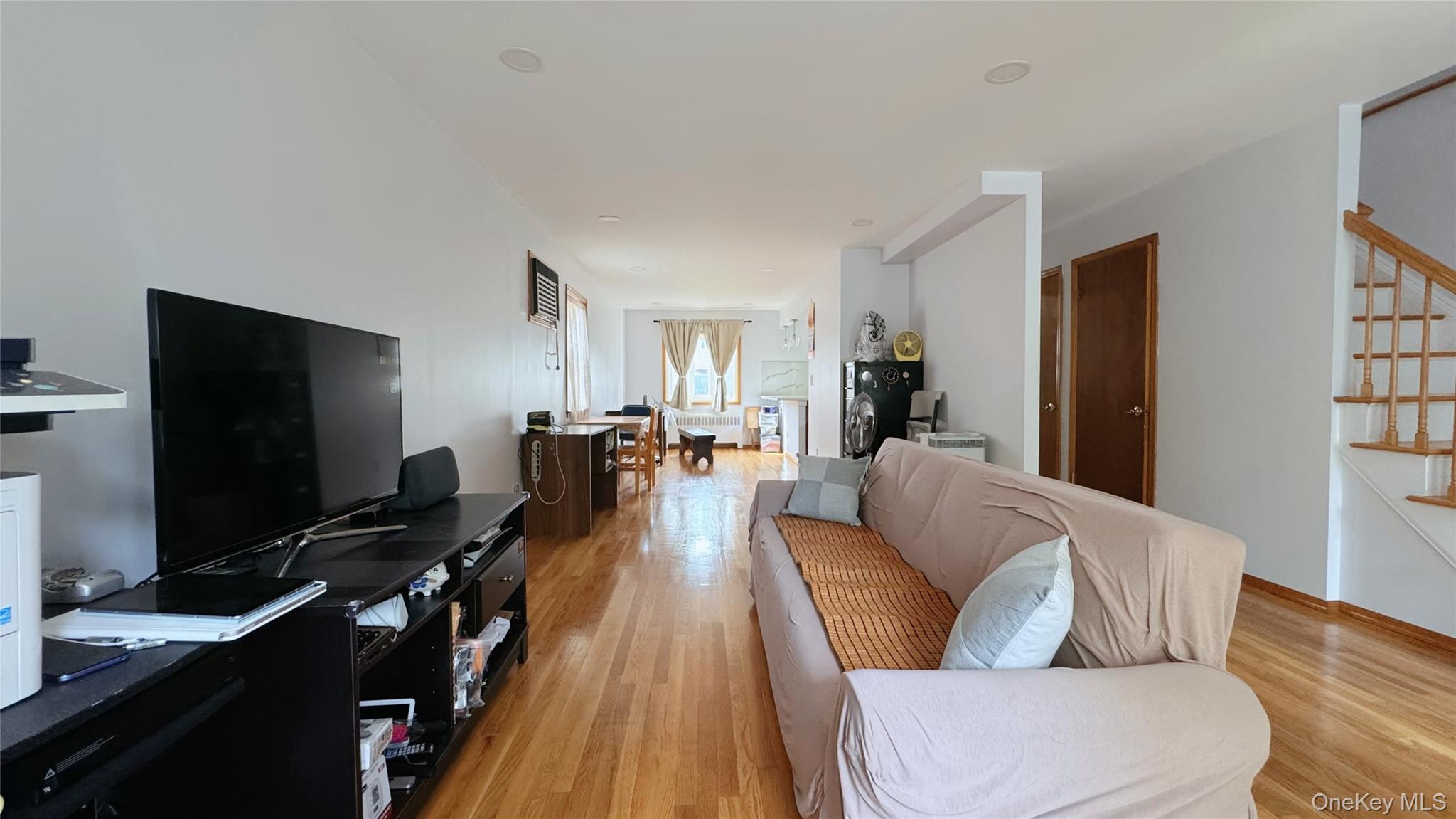168-12 19th Avenue Queens, NY 11357 - Photo 4 of 27 Living area featuring stairs and light wood-type flooring