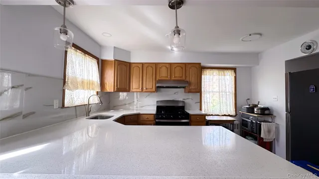 a kitchen with granite countertop a stove and a refrigerator