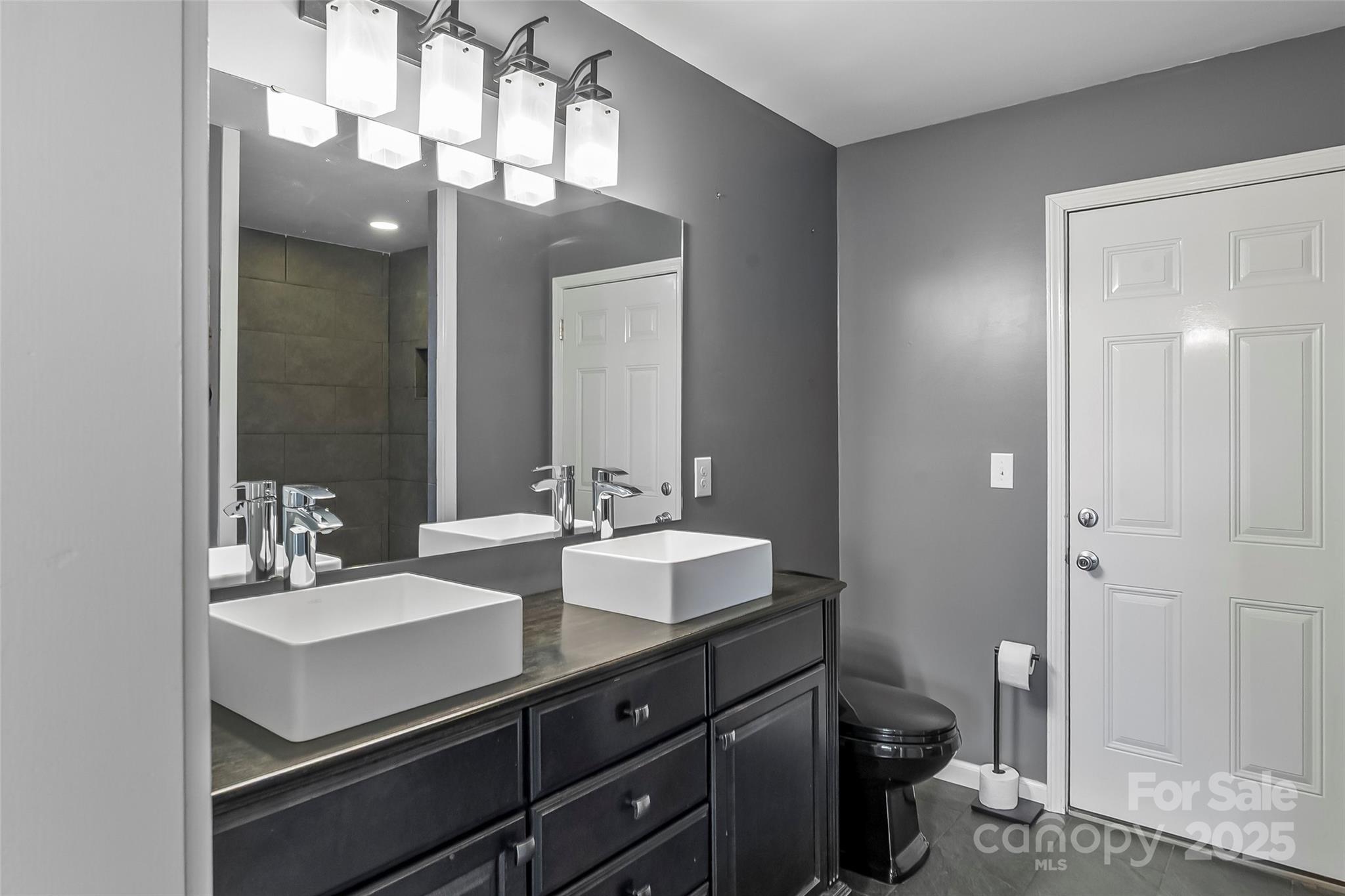 103 Clark Street Marion, NC 28752 - Photo 16 of 34 a bathroom with a sink vanity and a mirror