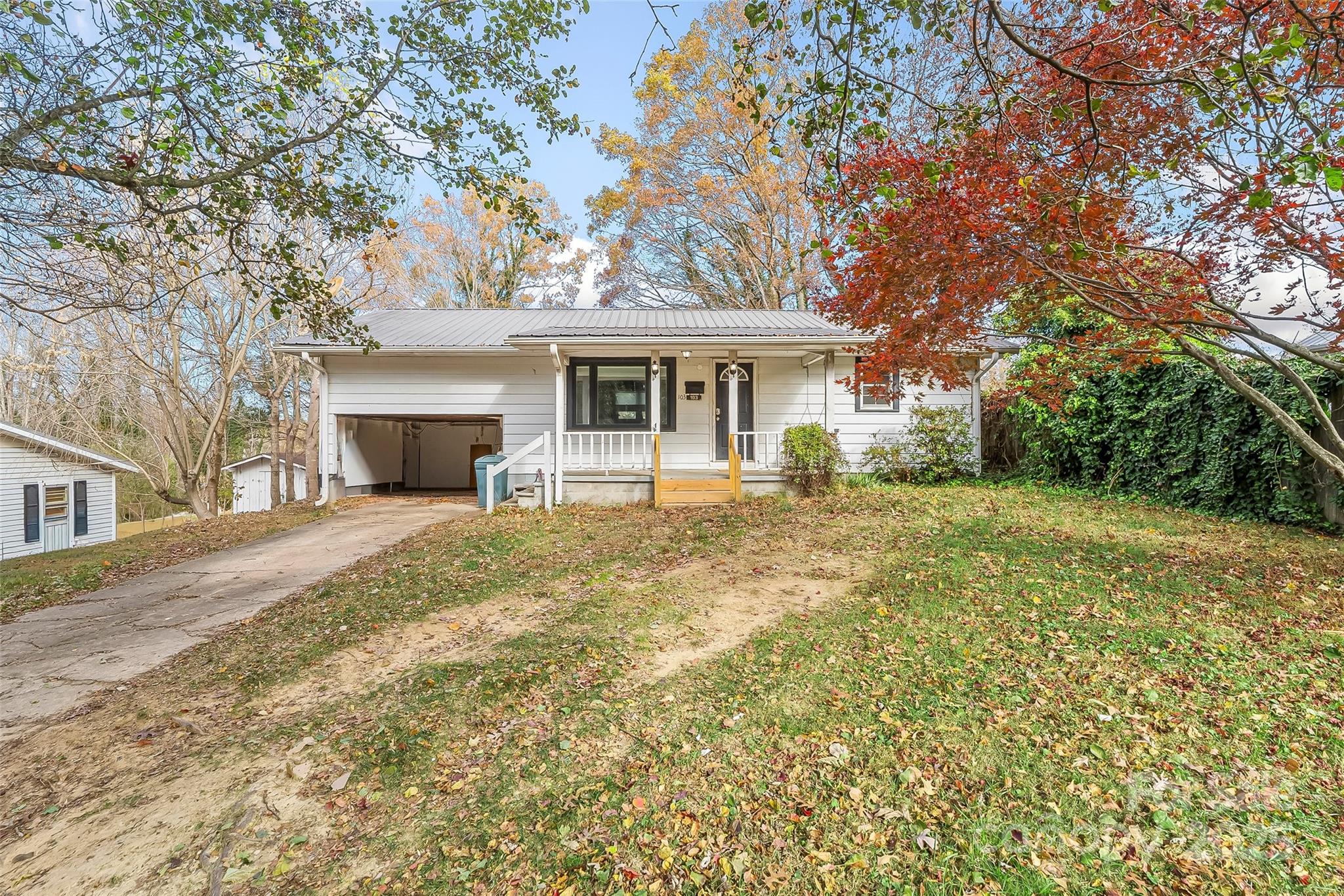 103 Clark Street Marion, NC 28752 - Photo 2 of 34 a front view of a house with yard and trees