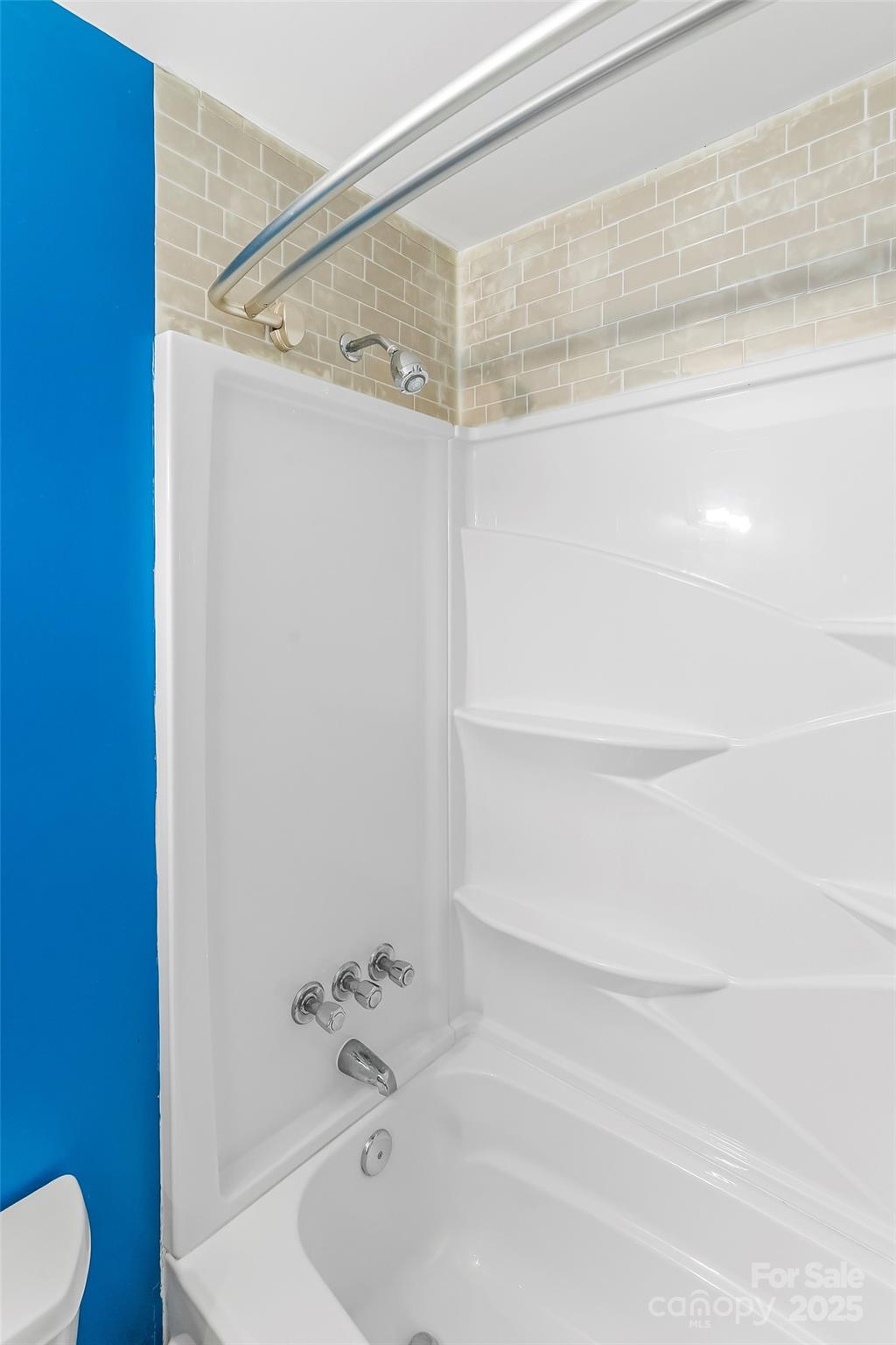 103 Clark Street Marion, NC 28752 - Photo 22 of 34 a bathroom with a shower and a toilet