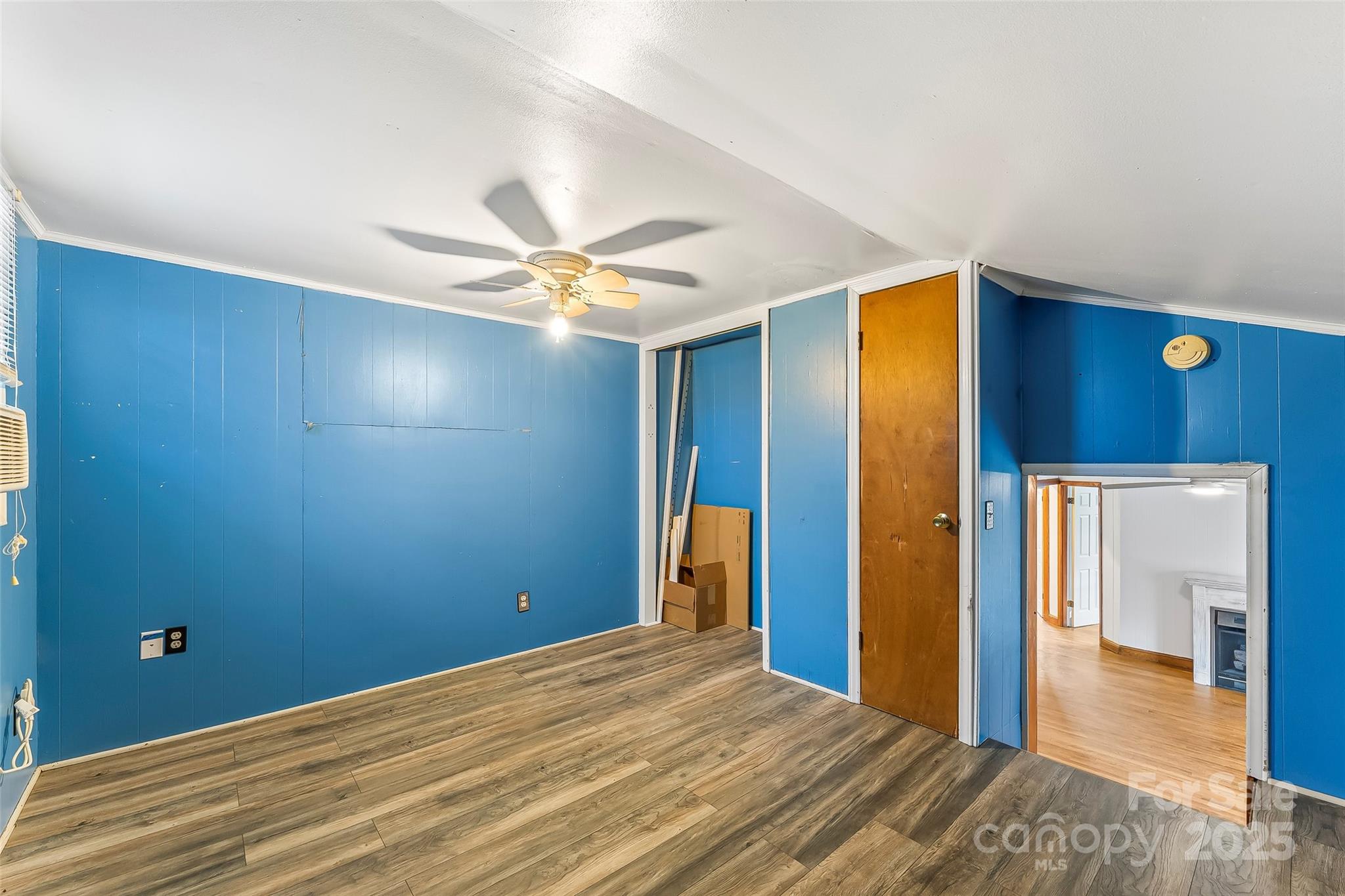 103 Clark Street Marion, NC 28752 - Photo 26 of 34 a view of a room with wooden floor and a ceiling fan