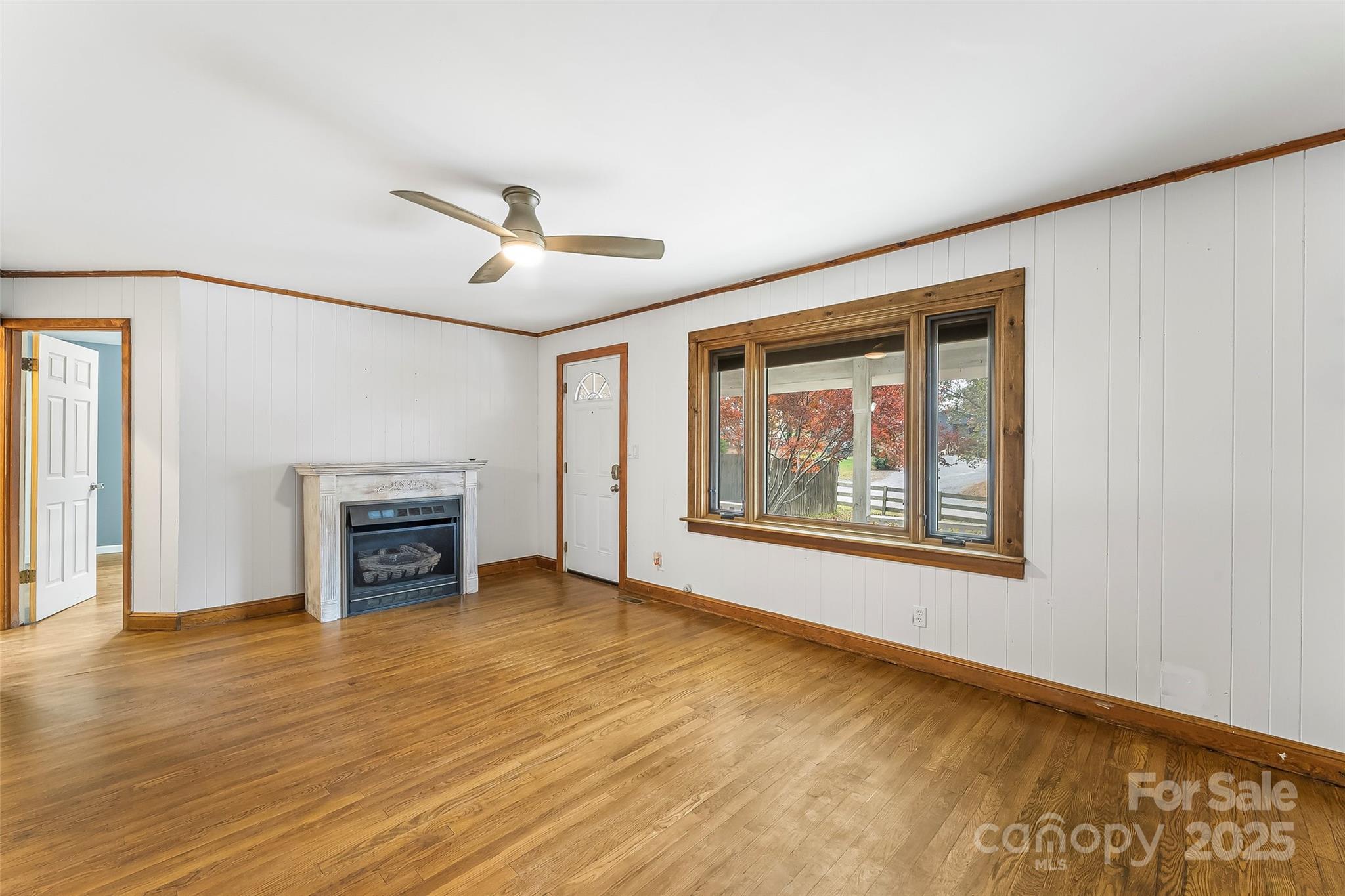 103 Clark Street Marion, NC 28752 - Photo 8 of 34 a view of an empty room with a fireplace and a window