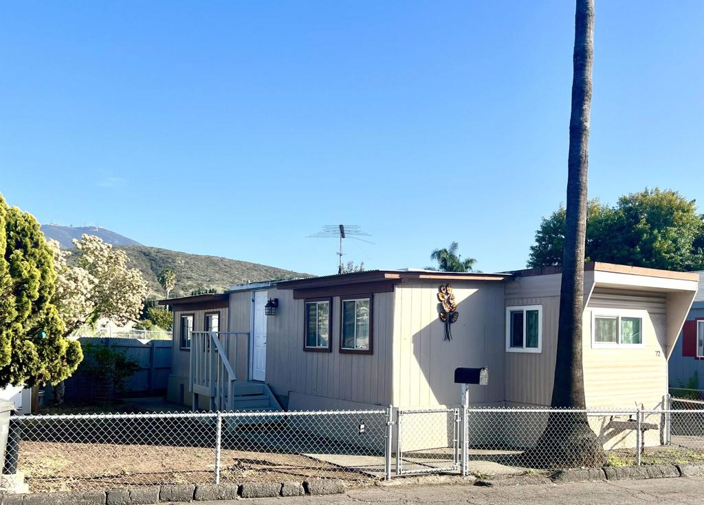 10707 Jamacha Boulevard, Unit 72 Spring Valley, CA 91978 - Photo 1 of 20 a front view of a house with a yard