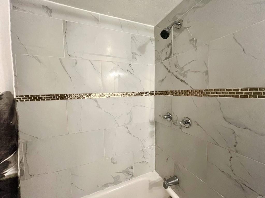 10707 Jamacha Boulevard, Unit 72 Spring Valley, CA 91978 - Photo 14 of 18 a bathroom with a bathtub and shower